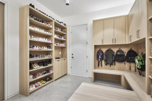 Custom designed mudroom shoe storage cabinetry.